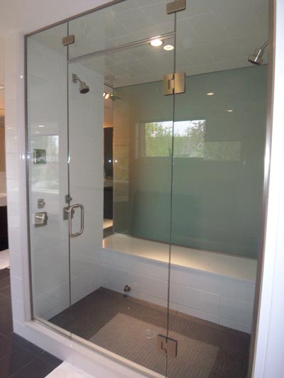 Steam door with operable transom & double panels - satin-etched glass wall separates shower & water closet - glass-to-glass hinges